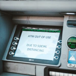 A close up of an atm machine with the screen on
