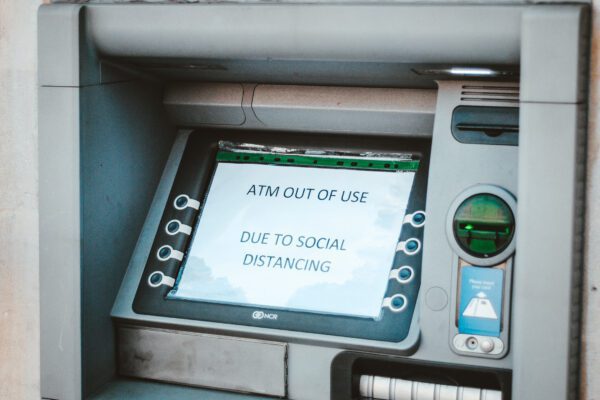 A close up of an atm machine with the screen on